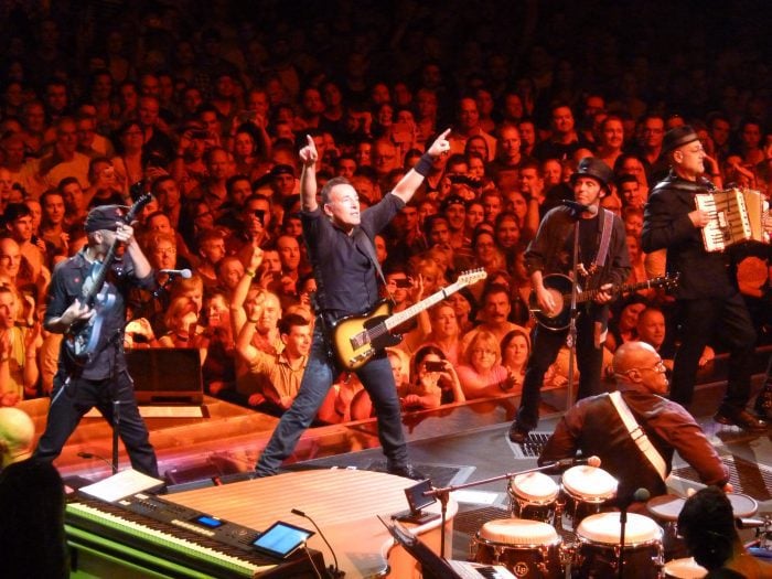 Bruce Springsteen and the E Street Band playing a concert.
