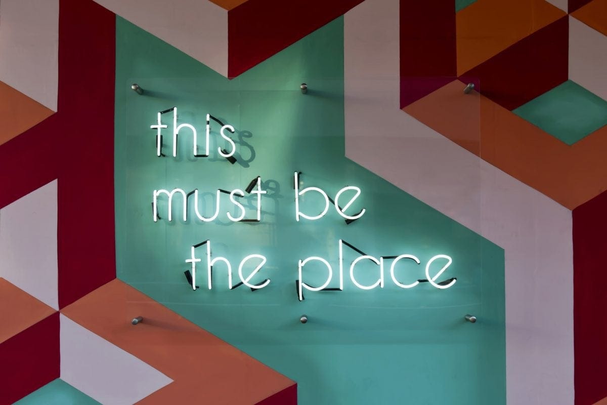 Neon sign saying "This must be the place"