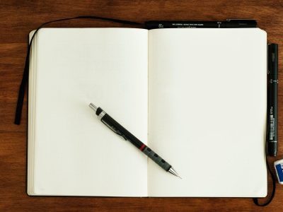 A blank notebook with a pen beside it