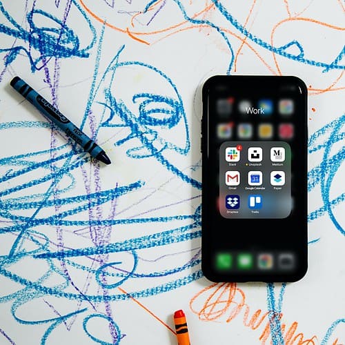 black iphone 4 on a background of crayon scribbles