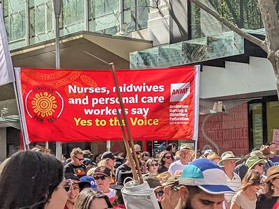 A flag saying "Nurses, midwives, and personal care workers say YES to the voice"